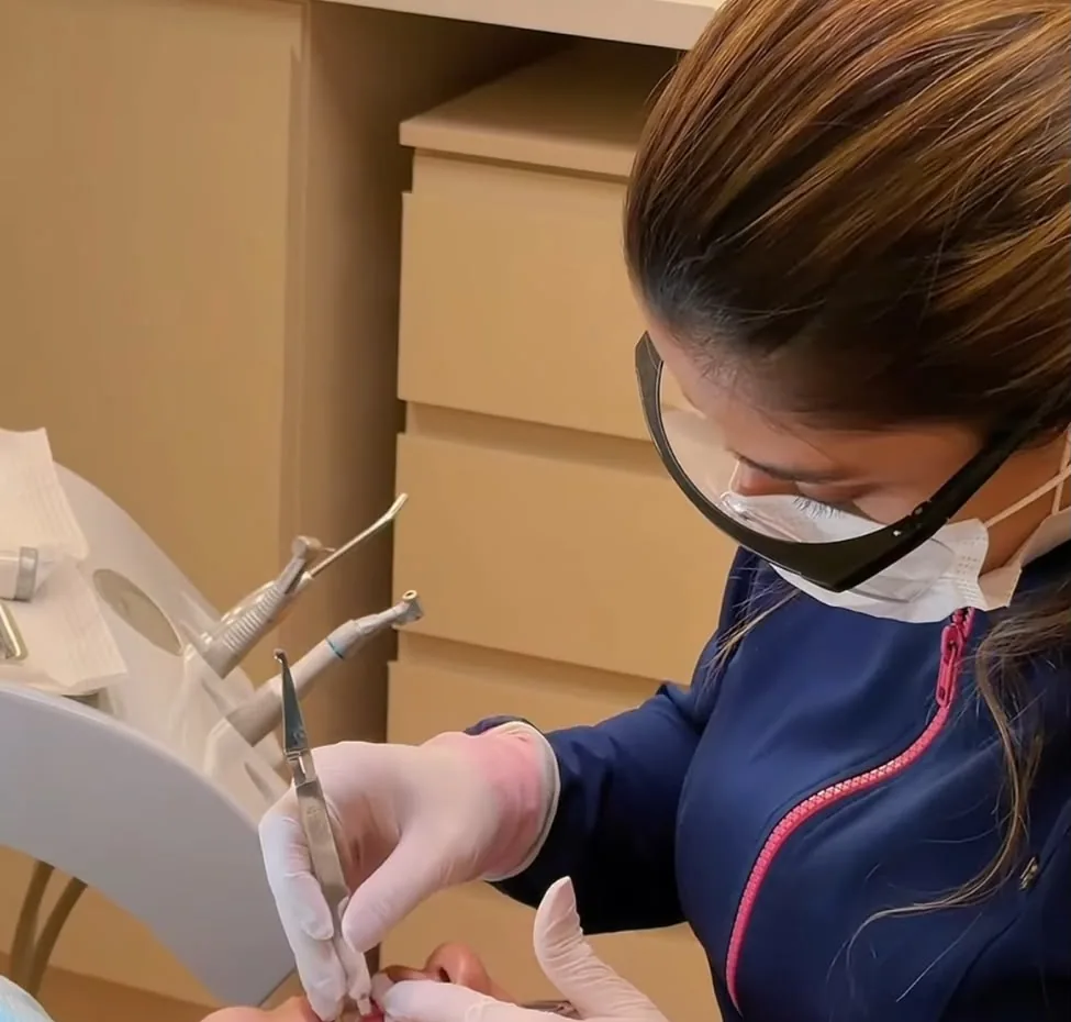 Profissional da equipe MR atendendo paciente na cadeira odontológica da Clínica MR, em Ji-Paraná